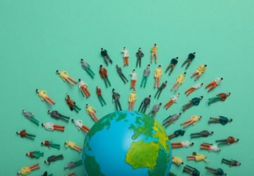 Concept of population with globe and toy people